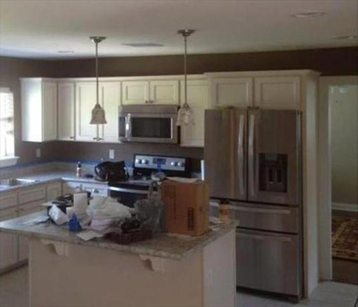 kitchen with white cabinets, grey walls and silver appliances