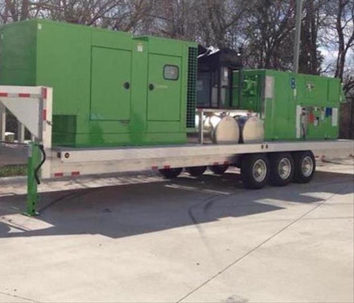 A large trailer with SERVPRO equipment on it