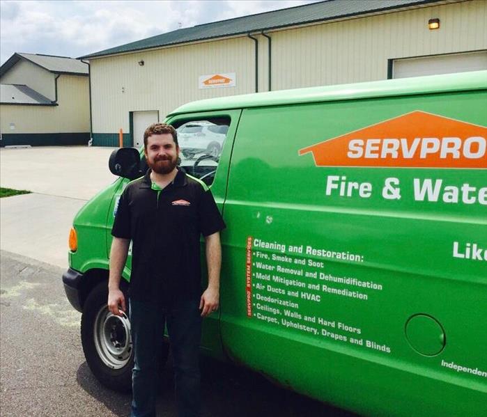A man standing in front of a SERVPRO van 