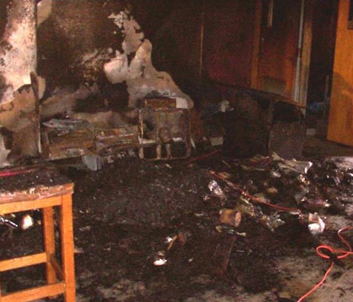 A kitchen with fire damage and soot