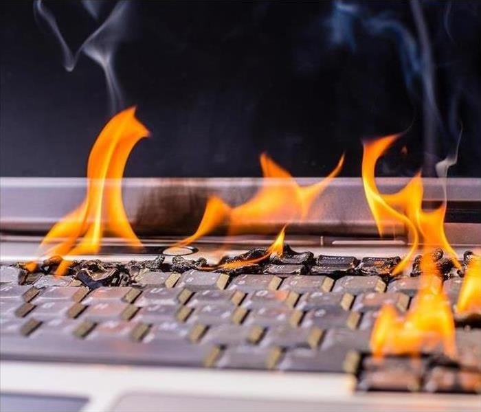 laptop on fire; flames on keyboard