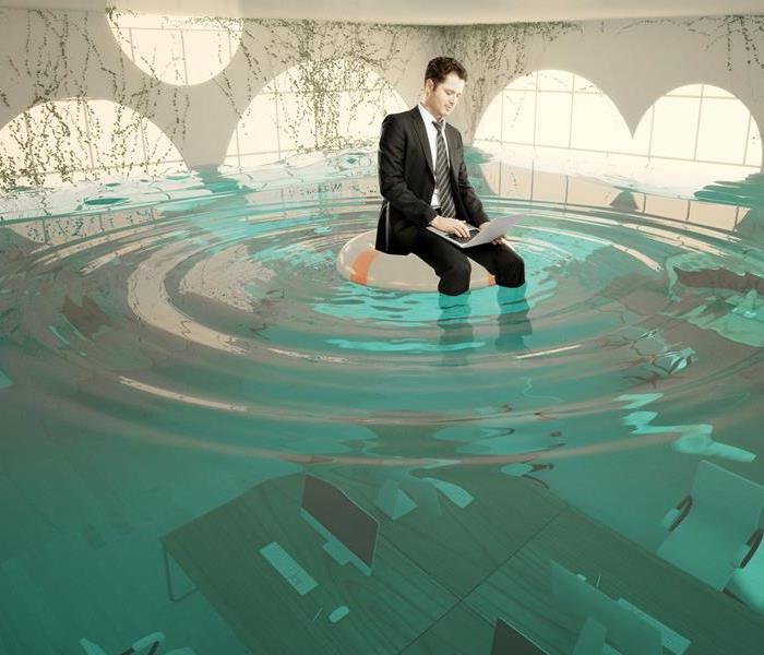 A man with a suit floating in water. 