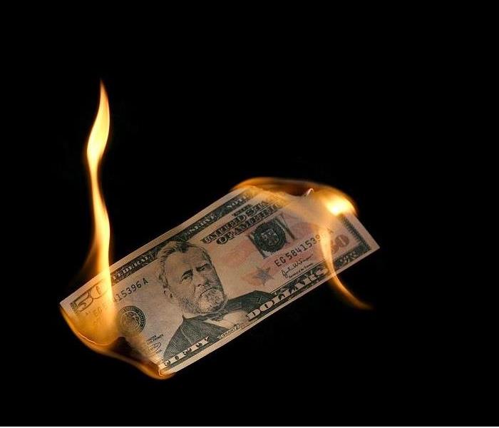 $50 bill burning on both endes
